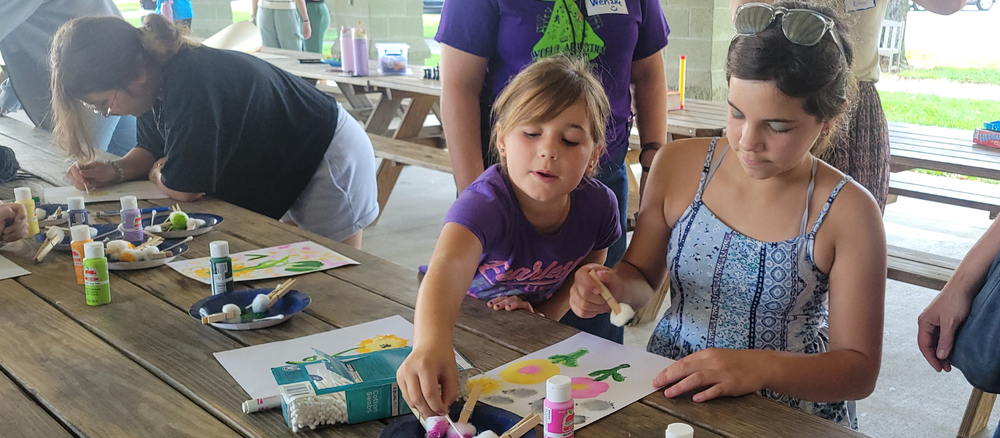 Two students paint during Falcons Connect