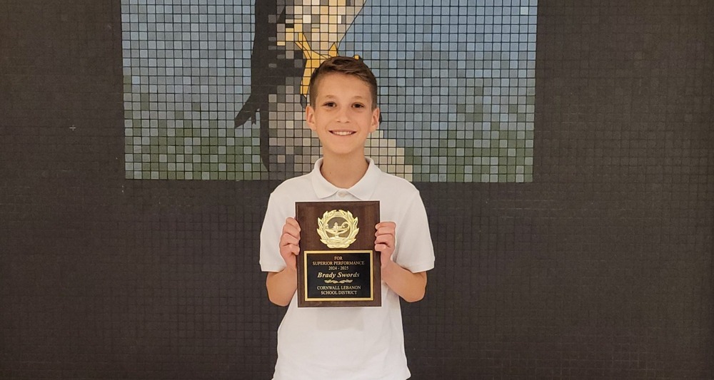 Child Holding Plaque