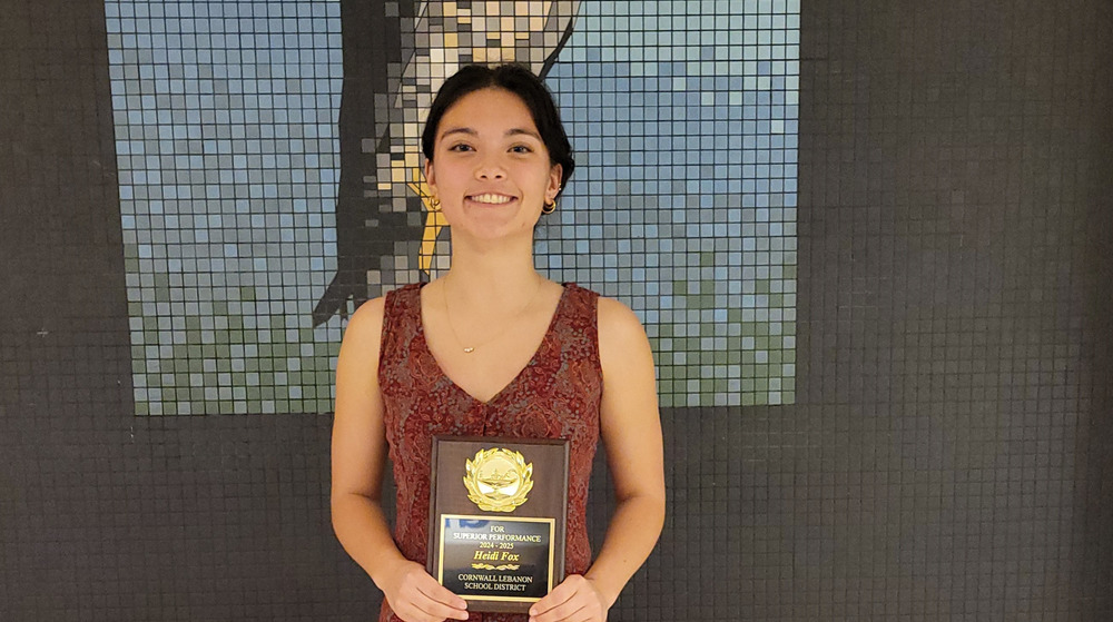 girl holding a plaque
