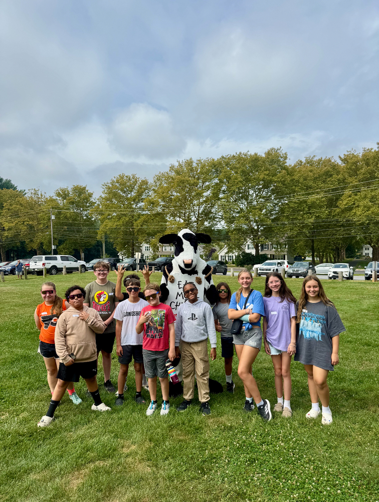 group of kids with cow mascot