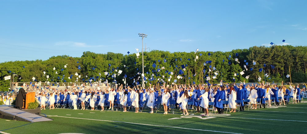 Cedar Crest High School Class of 2026 throws their caps during Commencement