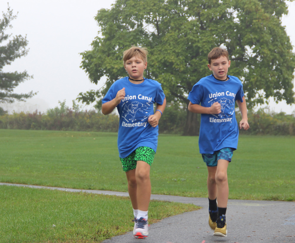 two boys running in Union Canal Elementary School shirts