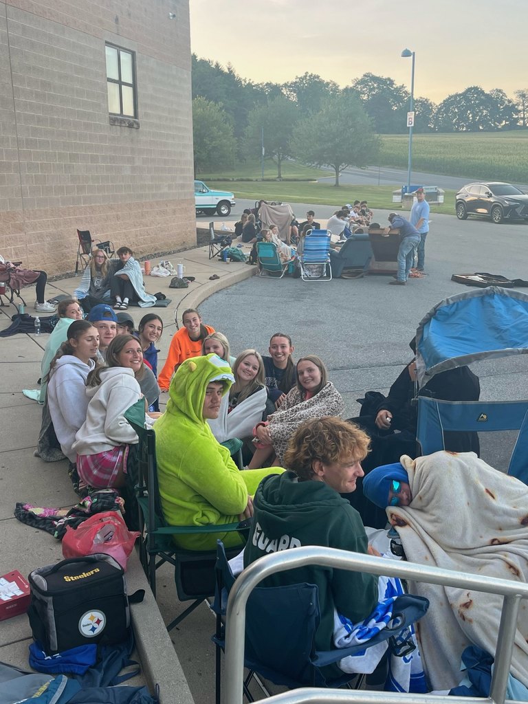Young people sitting on a curb
