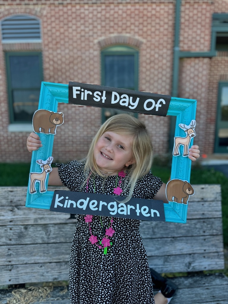girl peeking through a "First Day of Kindergarten" frame 