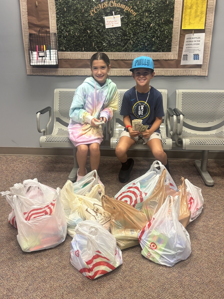 Seated boy and girl with filled Target bags and money