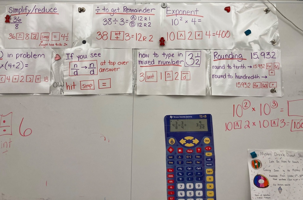 Whiteboard with calculator questions to solve