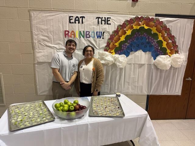 man and woman in front of table with apple slices 