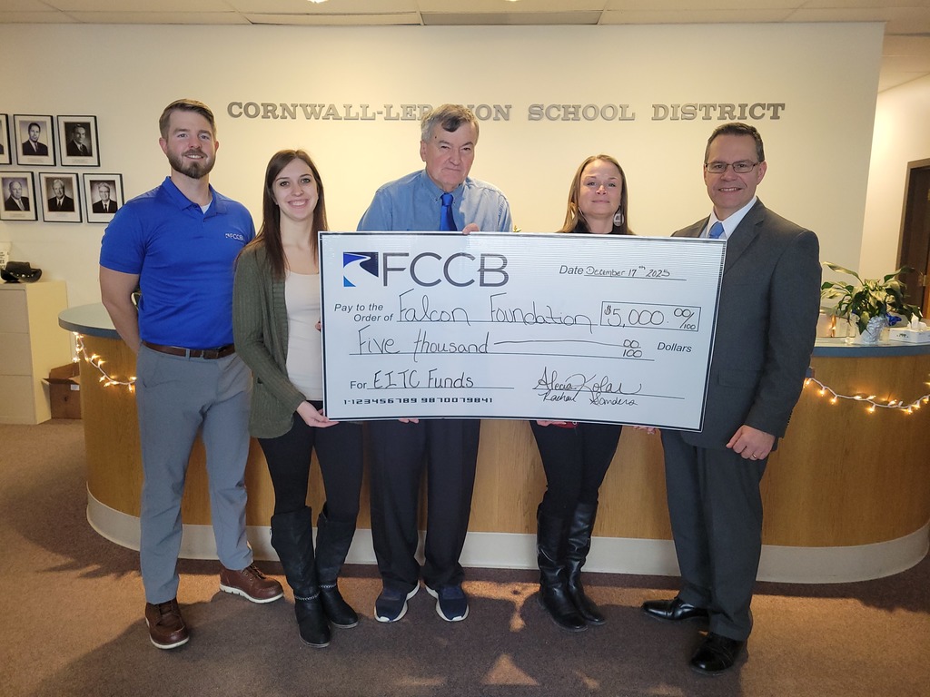 Three men and two women stand behind an oversized check for $5000, donated to the Falcon Foundation from First Citizens Community Bank