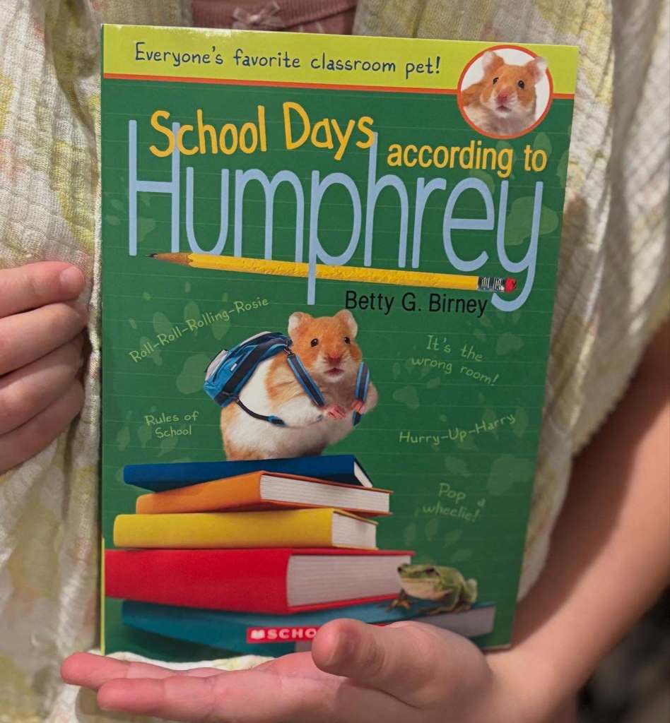 Child's hands holding the book, School Days according to Humphrey, by Betty G. Birney