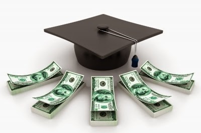 Five stacks of $100 bills in a semicircle in front of a black graduation cap