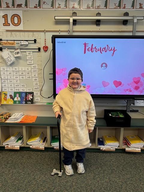 kindergarten boy dressed like an old man with a cane