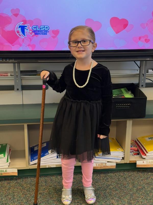 kindergarten girl dressed like an old lady with a cane