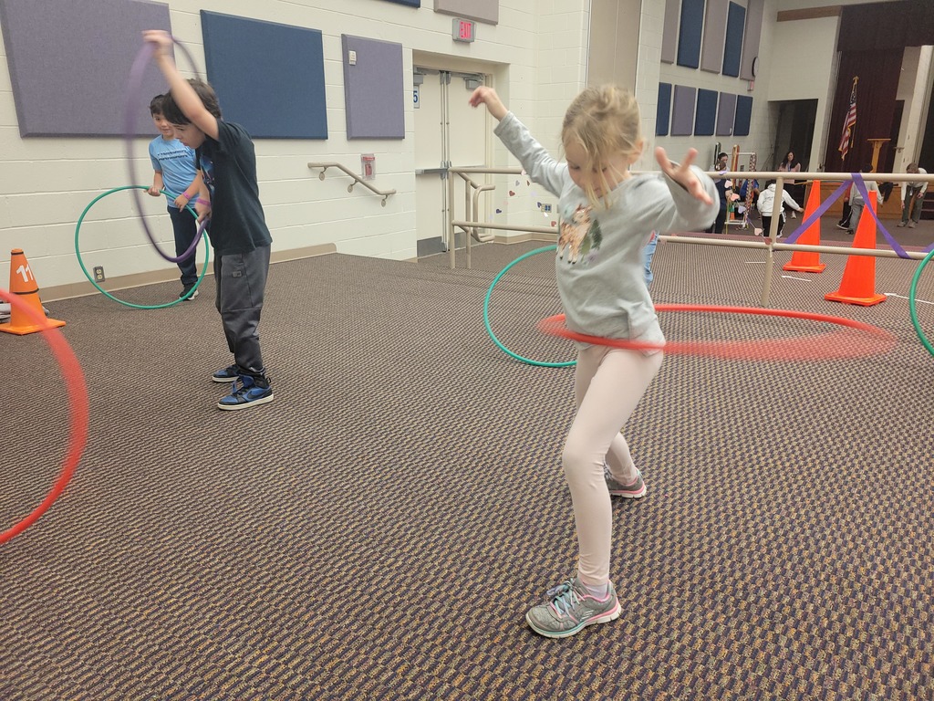 young girl swirling a hula hoop around her hips