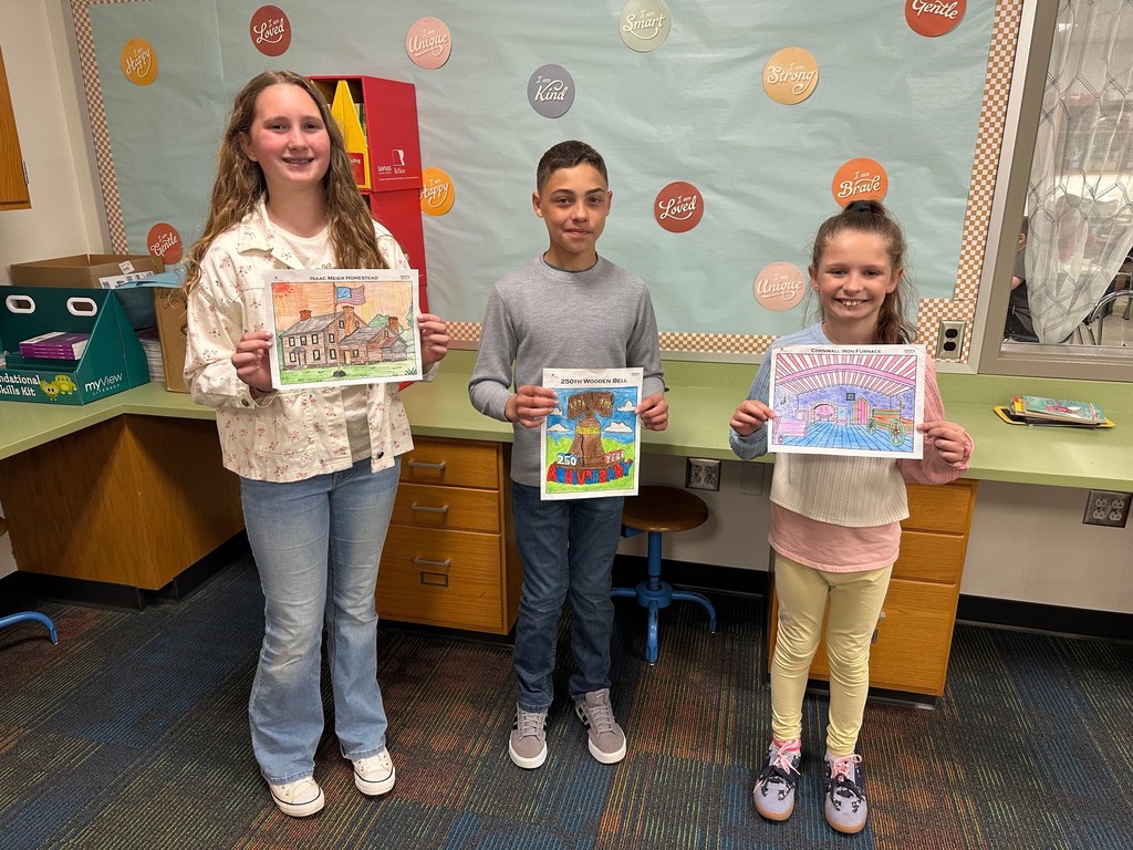 Three elementary students holding completed coloring pages