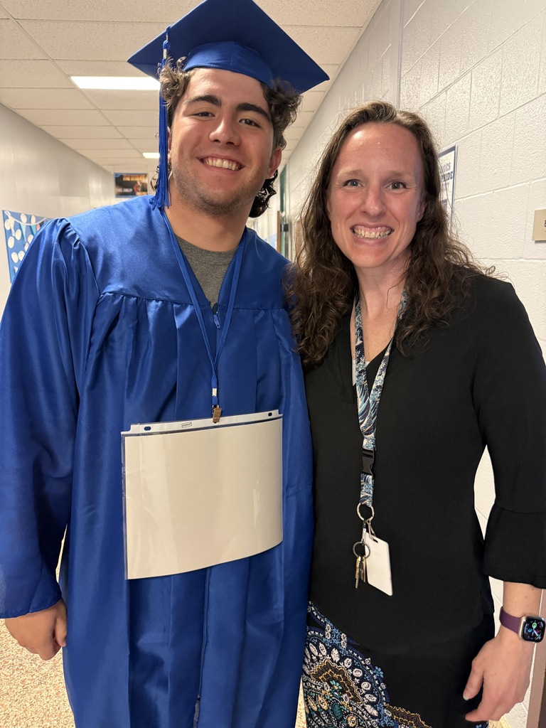 A member of the Class of 2026 poses for a photo with a faculty member