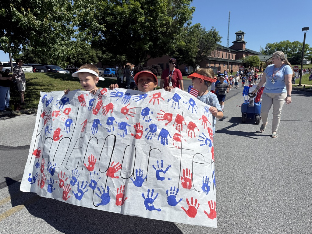 Kindergarten students hold their banner during the parade