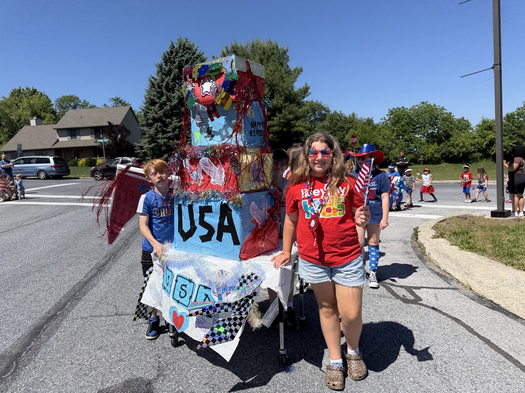 Students pose for a photo with their patriotic parade float
