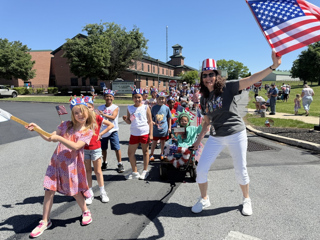 Elementary students and their teacher pose for a photo during the parade