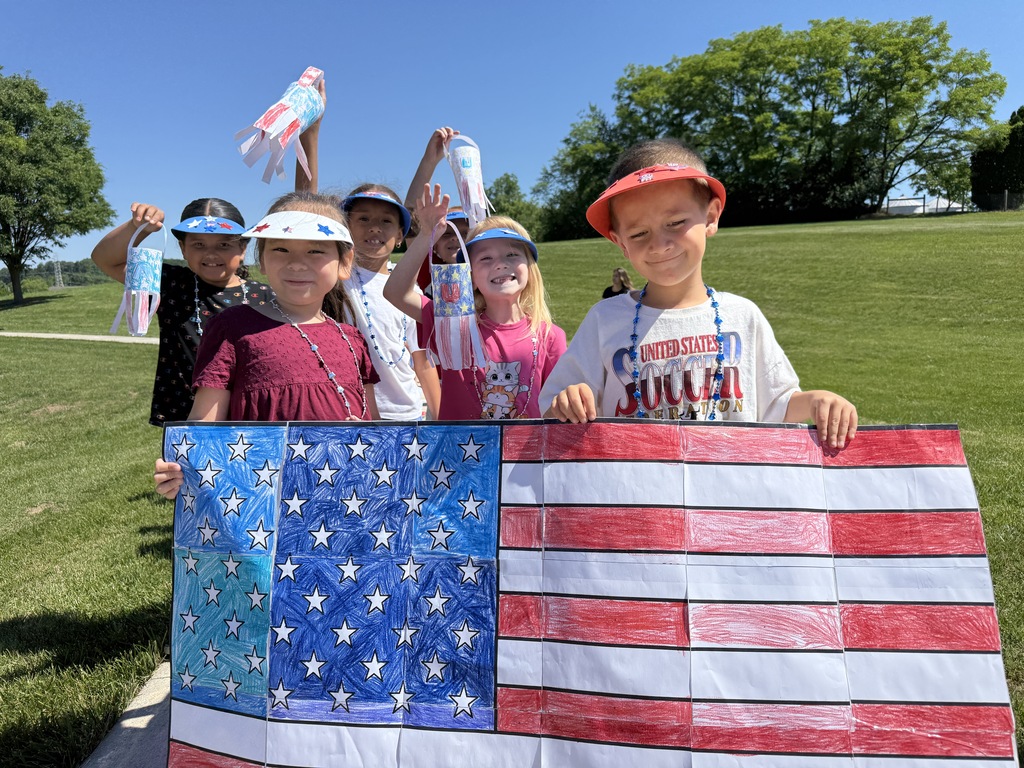 Elementary students showcase their patriotic artwork before the parade