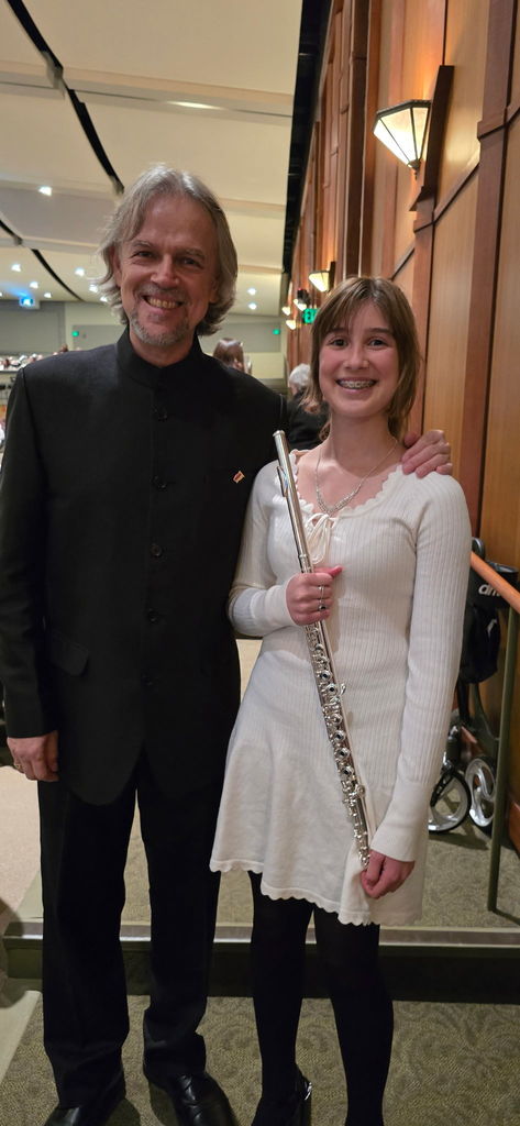 A student with her guest conductor Dr. Ruben Gómez at a concert band festival.