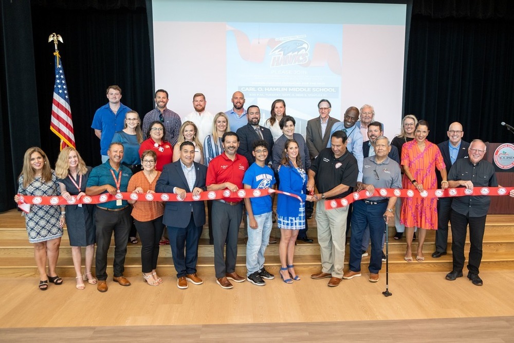 CCISD employees holding ribbon at Hamlin Middle School