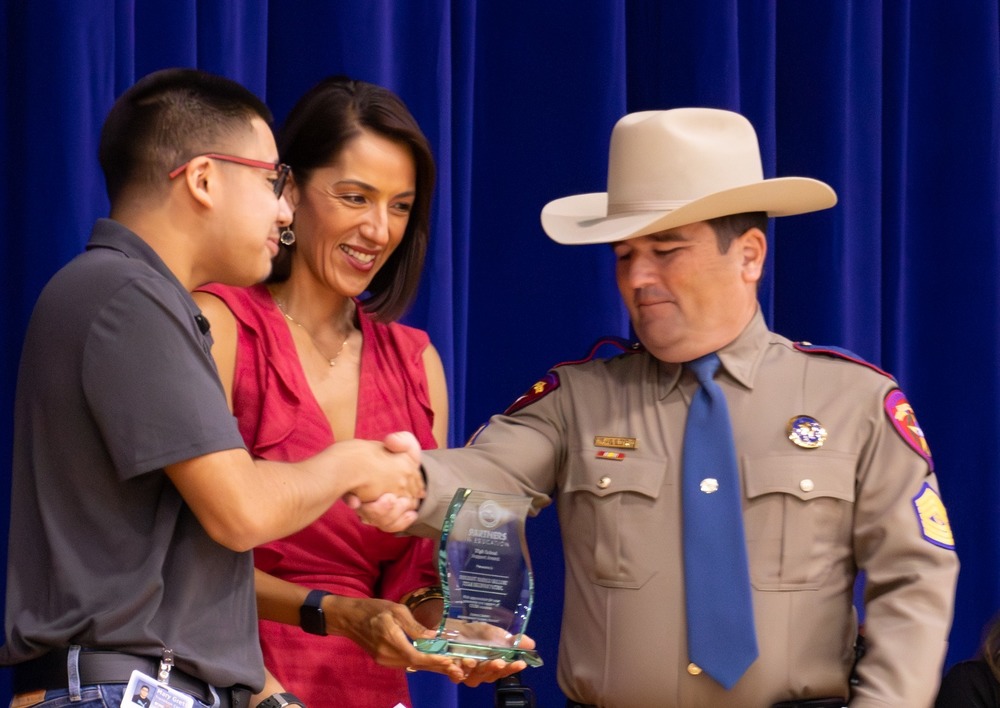 Board President Dolly Gonzales Trolley presents an Award at the Partners in Education luncheon