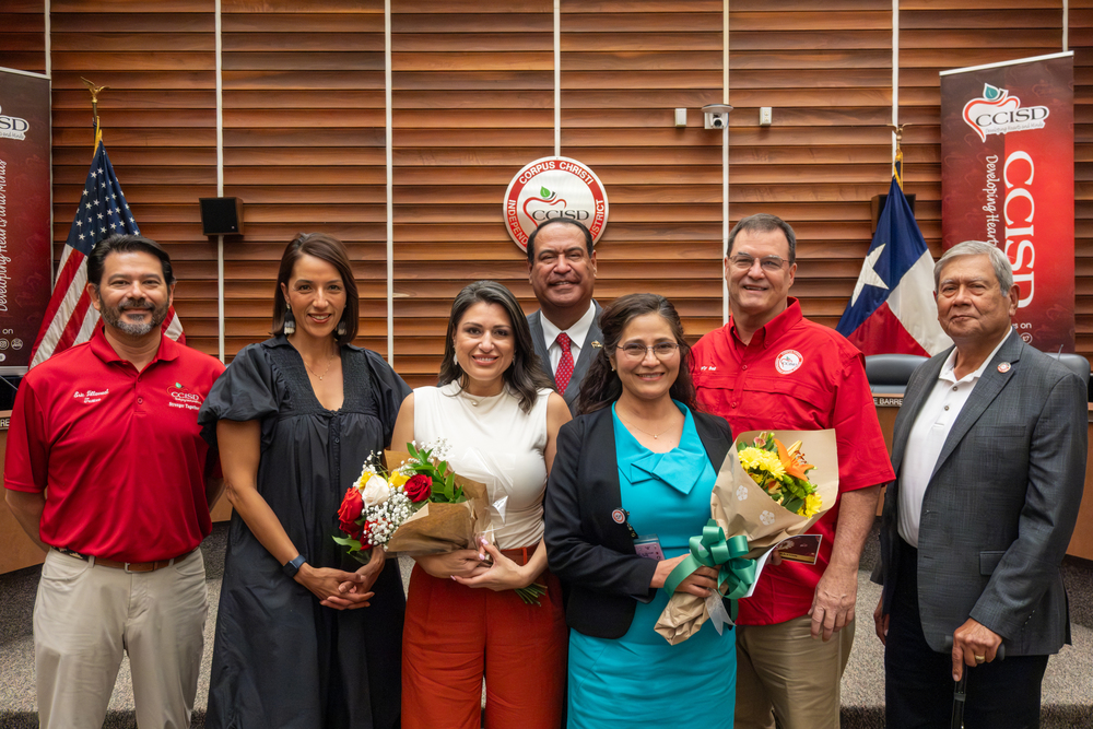 Teacher of the Year winners stand with superintendent and school board trustees.
