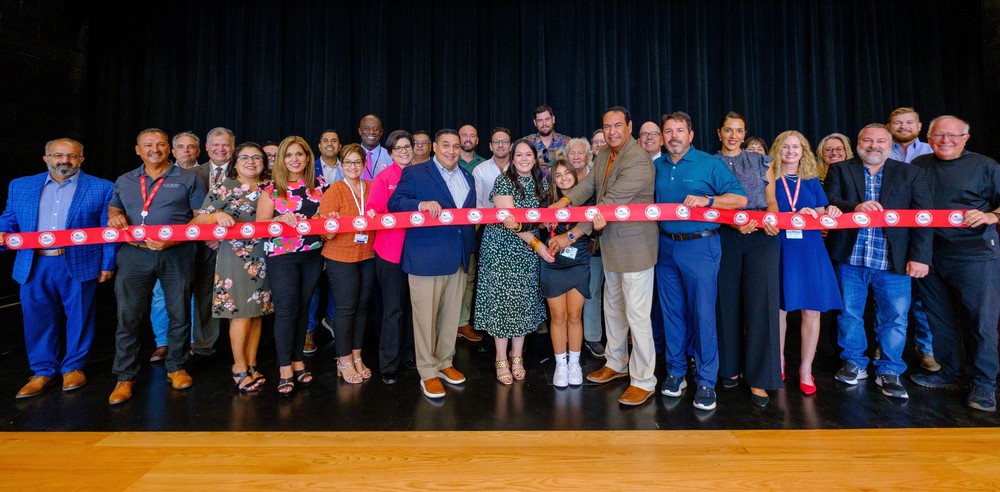 District leaders holding the ribbon at lex middle school