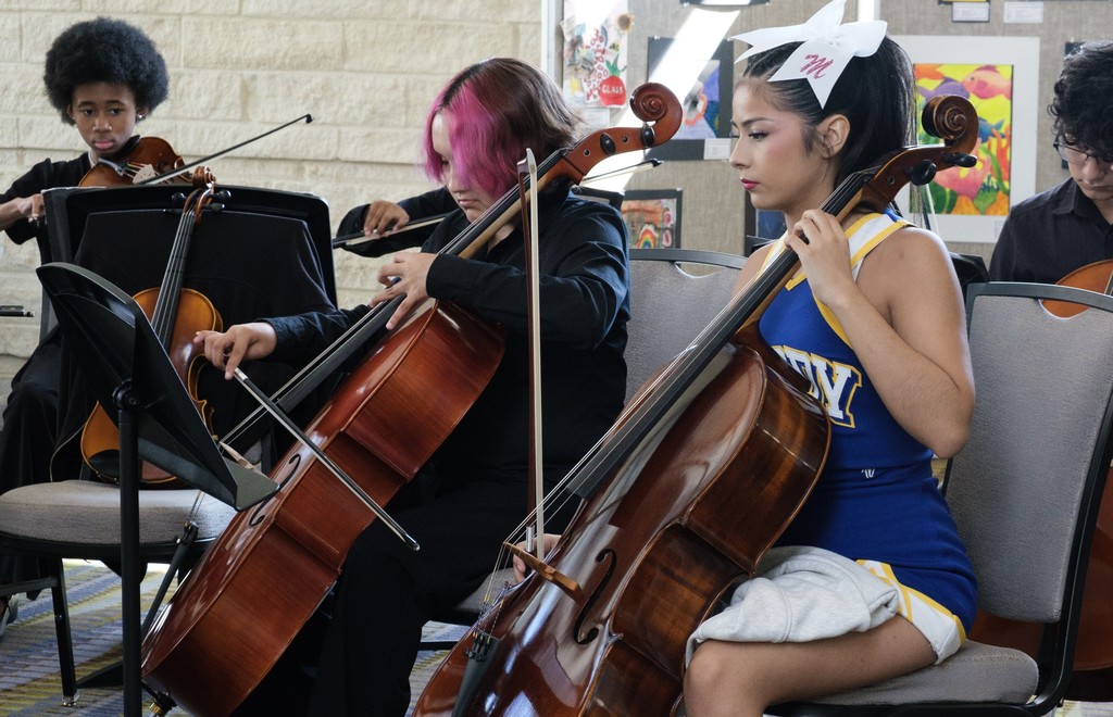 moody orchestra and a moody cheerleader playing an instrament