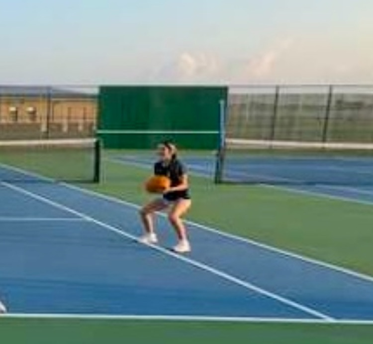 tennis team working out with pumpkins.