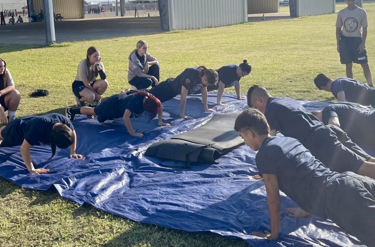 Carroll High School NJROTC cadets compete at Flour Bluff, demonstrating strength, teamwork, and precision through drill formations and physical training exercises.