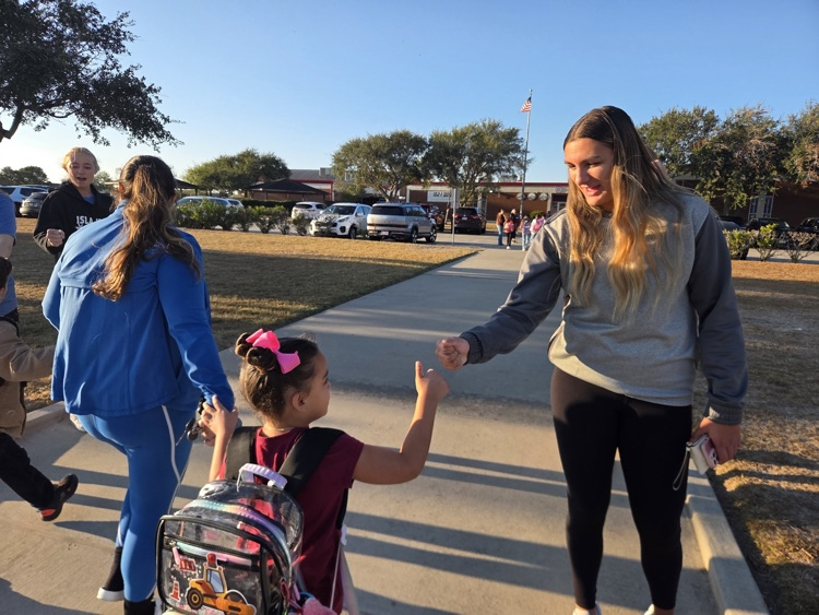 islander volleyball team greeting students Friday morning.