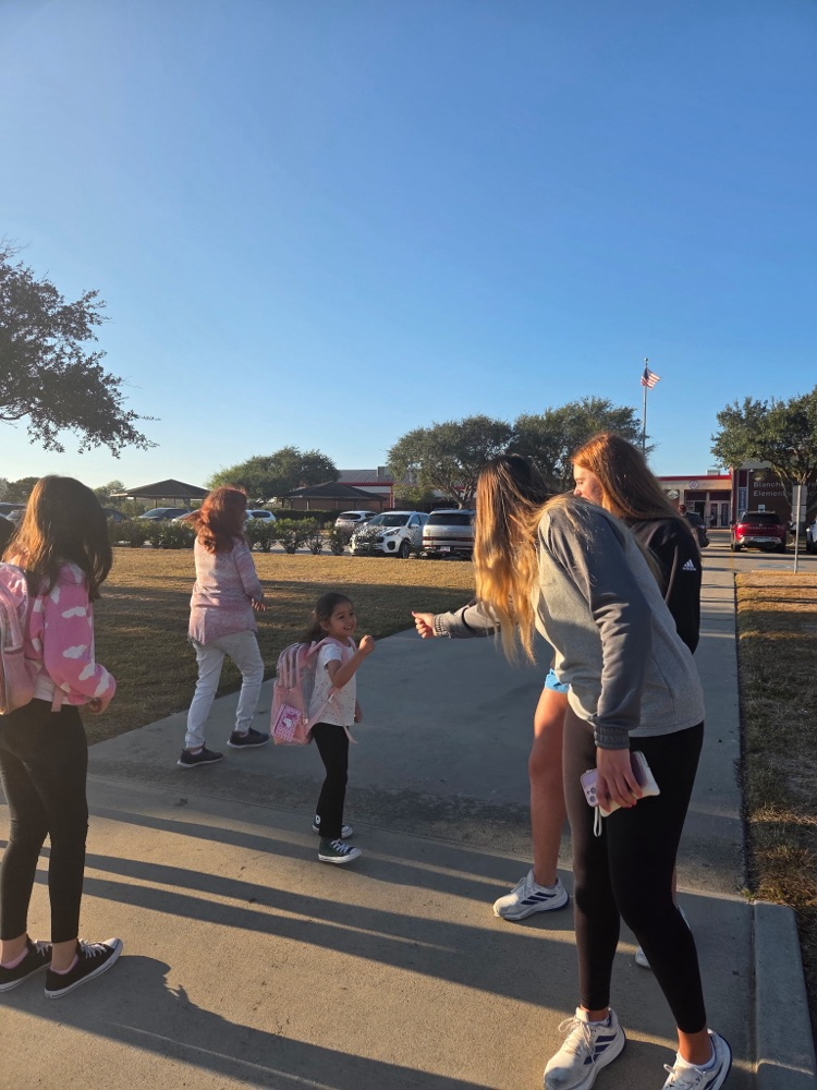 islander volleyball team greeting students Friday morning.
