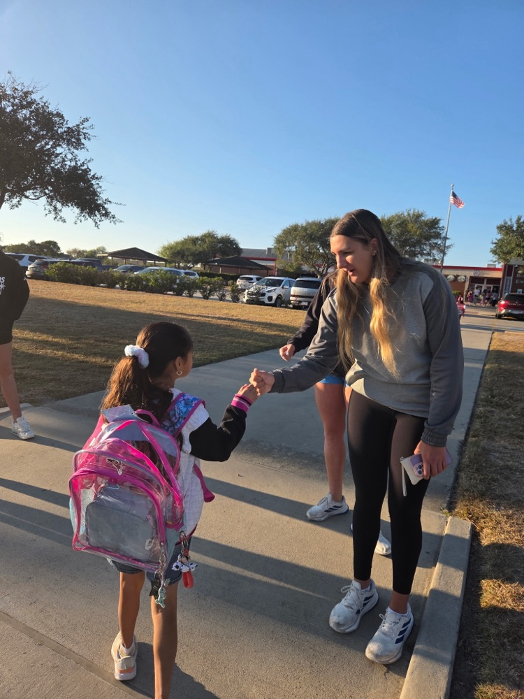 islander volleyball team greeting students Friday morning.