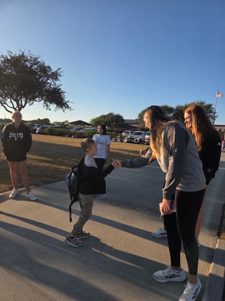 islander volleyball team greeting students Friday morning.