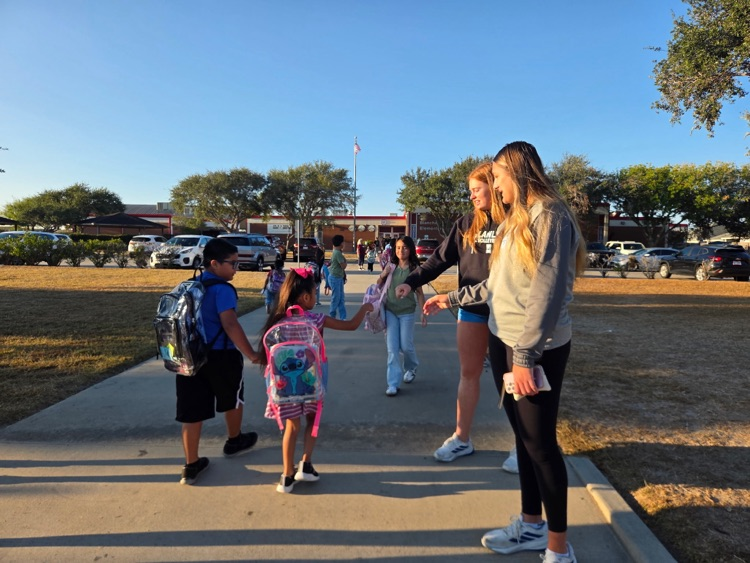 islander volleyball team greeting students Friday morning.