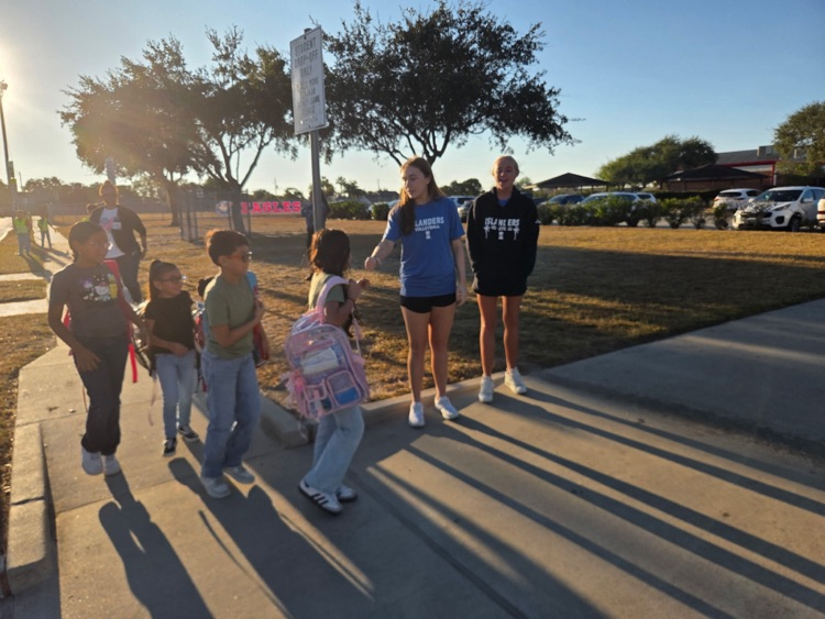islander volleyball team greeting students Friday morning.