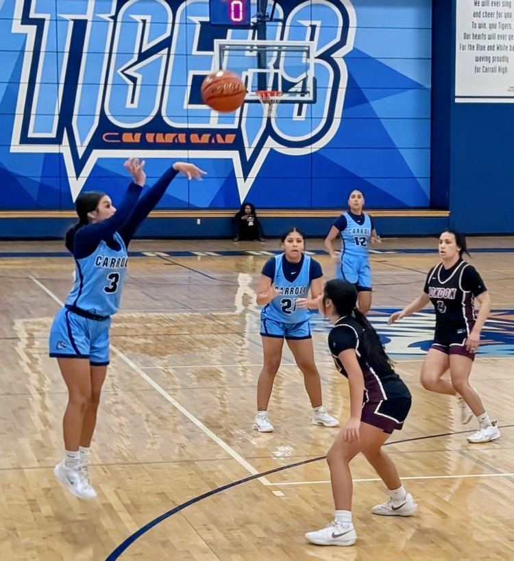 Carroll Lady Tigers basketball players in blue uniforms battle against the London Pirates