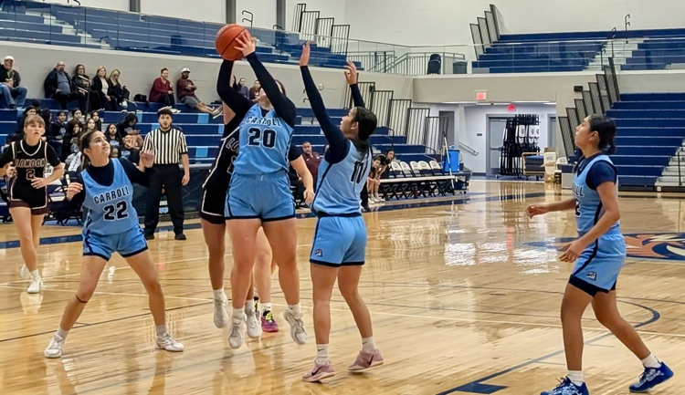 Carroll Lady Tigers basketball players in blue uniforms battle against the London Pirates