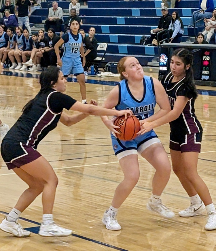 Carroll Lady Tigers basketball players in blue uniforms battle against the London Pirates