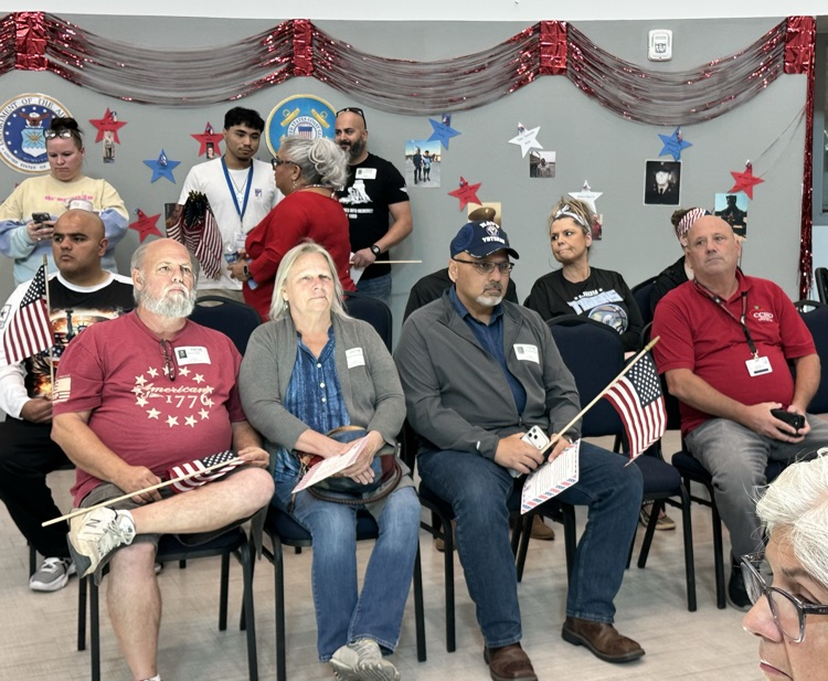Alt text: Photos show Carroll High School’s Veterans Day celebration featuring veterans seated with American flags,