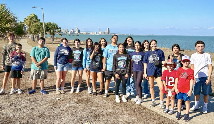 Students from Carroll’s girls basketball team help remove American flags from the Flags for Heroes display by the bay.