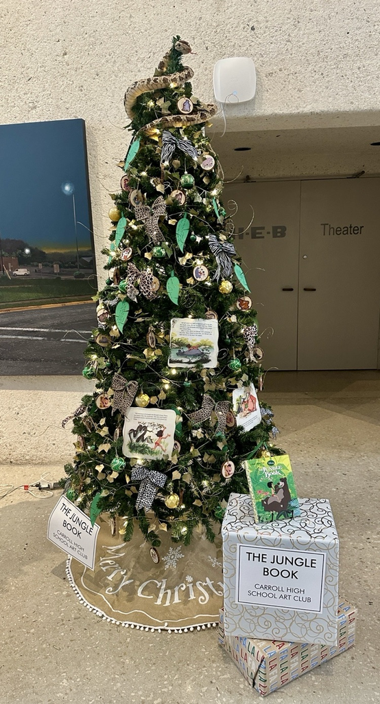 Students and sponsors from Carroll pose proudly beside their decorated literary-themed Christmas trees at the Art Museum of South Texas.