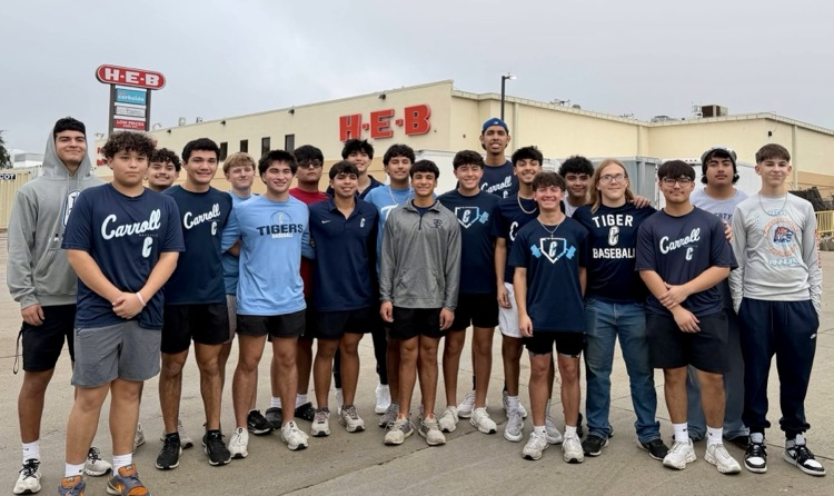 Carroll High School baseball players unloading boxes of food while volunteering in the community. 