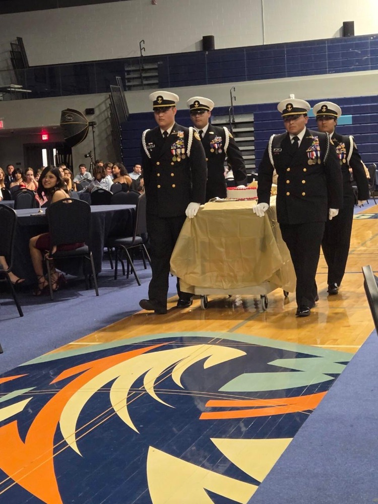 ⸻ Short alt text (one): ROTC cadets in formal uniform during the Military Ball inside the school gym.