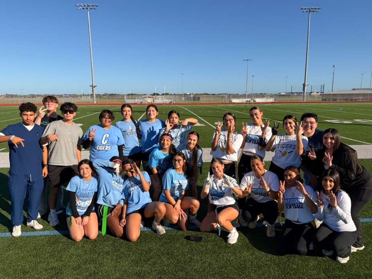 Students celebrating and posing during the junior powderpuff football game.