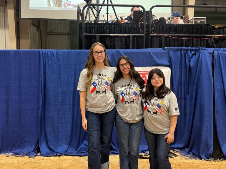 Carroll FFA students stand with a young exhibitor holding a ribbon during the NCJLS All-Star Show.