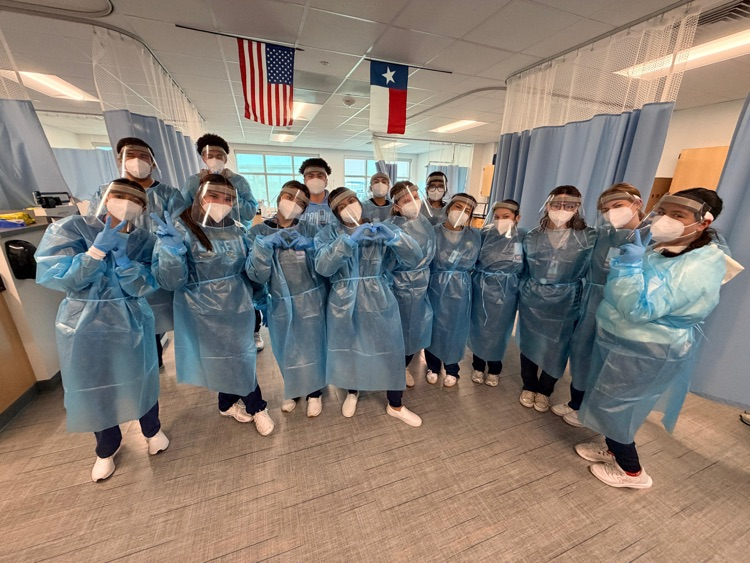 Medical Assistant students wearing PPE during a hands-on donning and doffing lab in class.