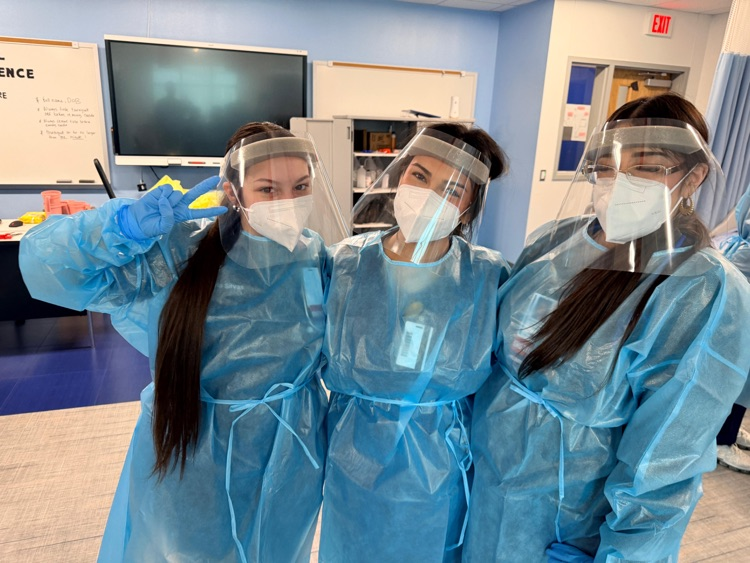 Medical Assistant students wearing PPE during a hands-on donning and doffing lab in class.