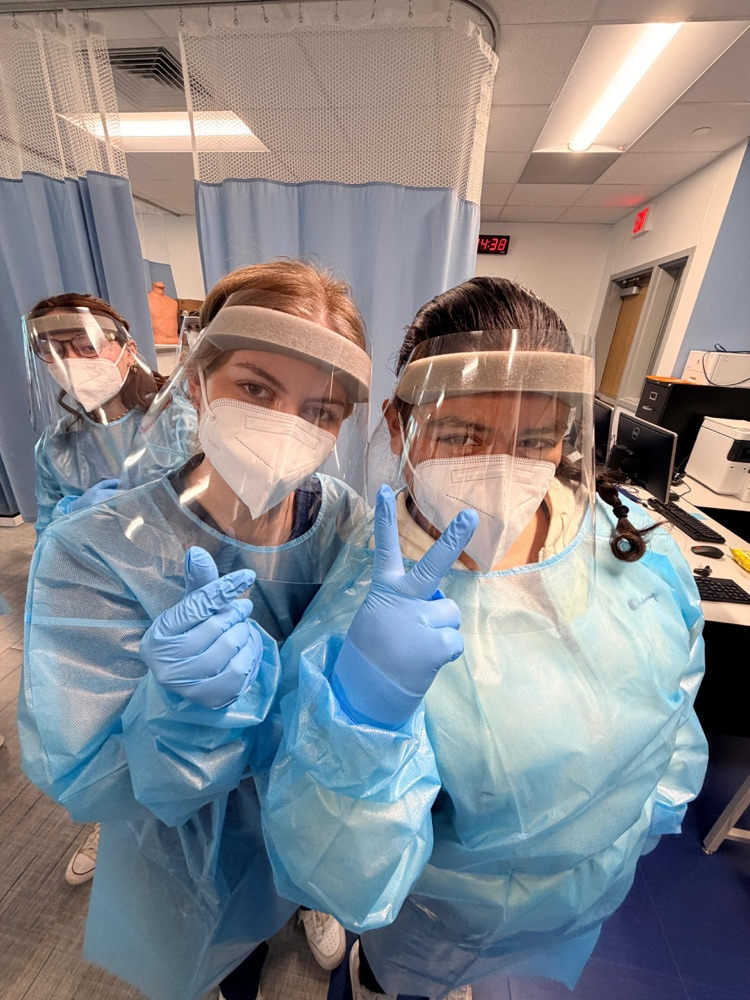 Medical Assistant students wearing PPE during a hands-on donning and doffing lab in class.